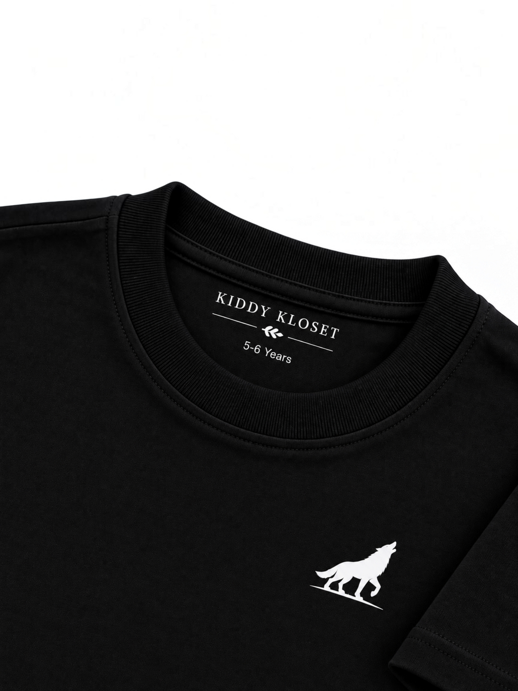 Close up of tonal black ribbed crew neckline, Kiddy Kloset neck label and white wolf logo