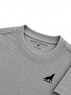Close up of tonal grey ribbed crew neckline, Kiddy Kloset neck label and black wolf logo
