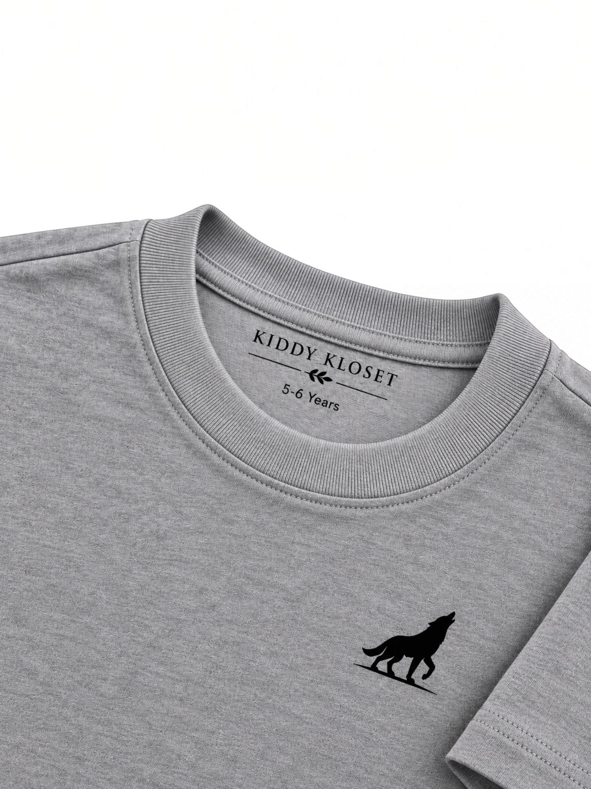 Close up of tonal grey ribbed crew neckline, Kiddy Kloset neck label and black wolf logo