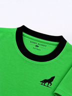 Close up of black ribbed crew neckline, Kiddy Kloset neck label and black wolf logo on parrot green tee