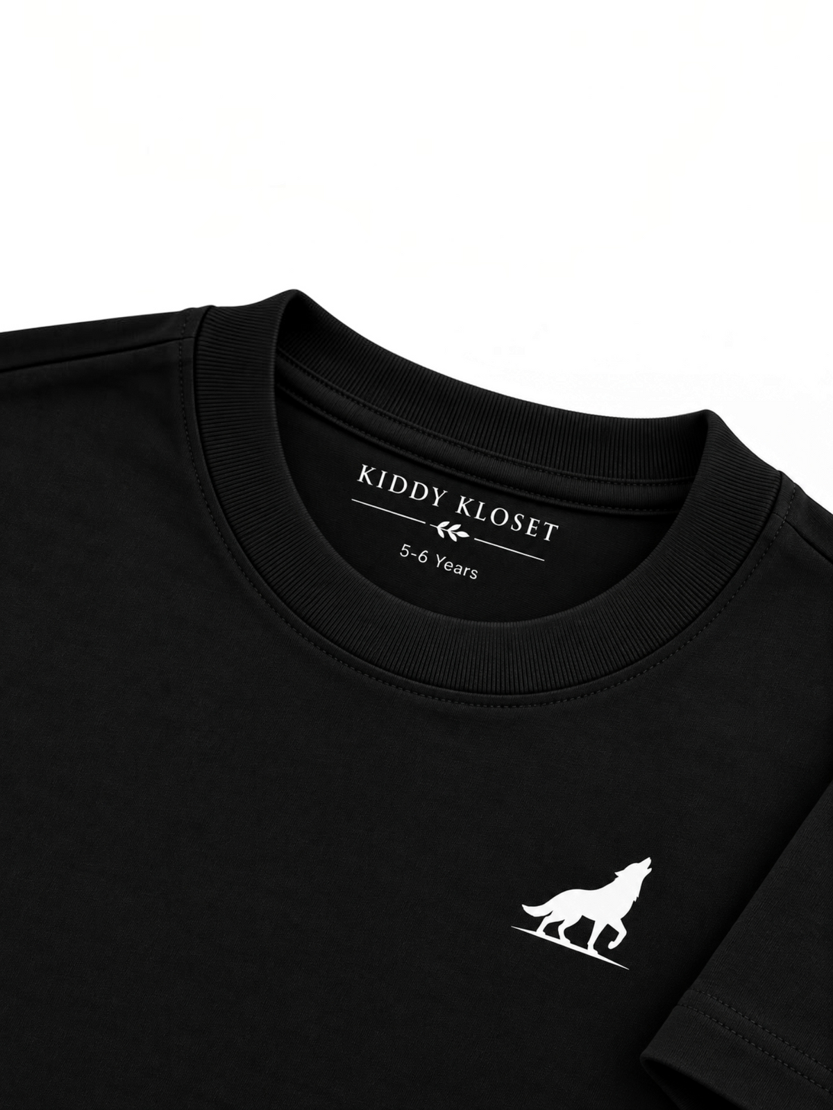 Close up of tonal black ribbed crew neckline, branded neck print and white wolf logo