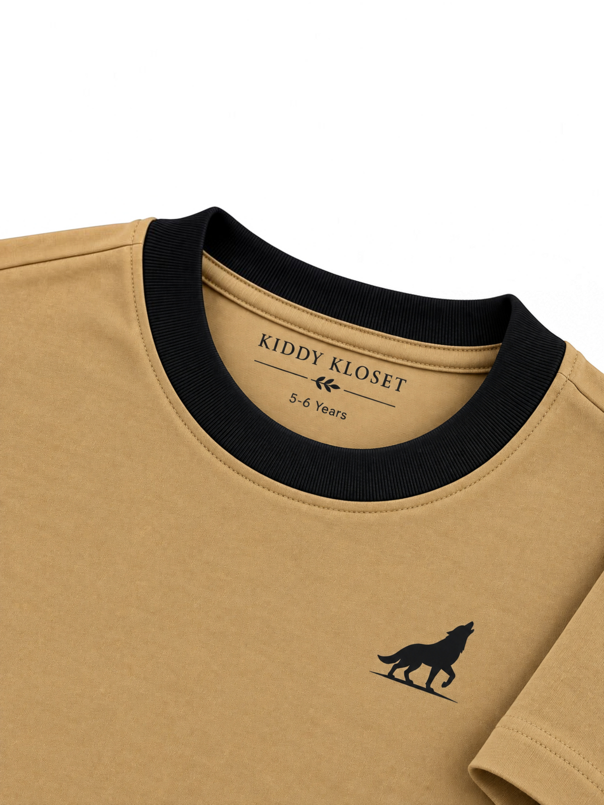 Close up of black ribbed crew neckline, branded neck print and black wolf logo on camel tee