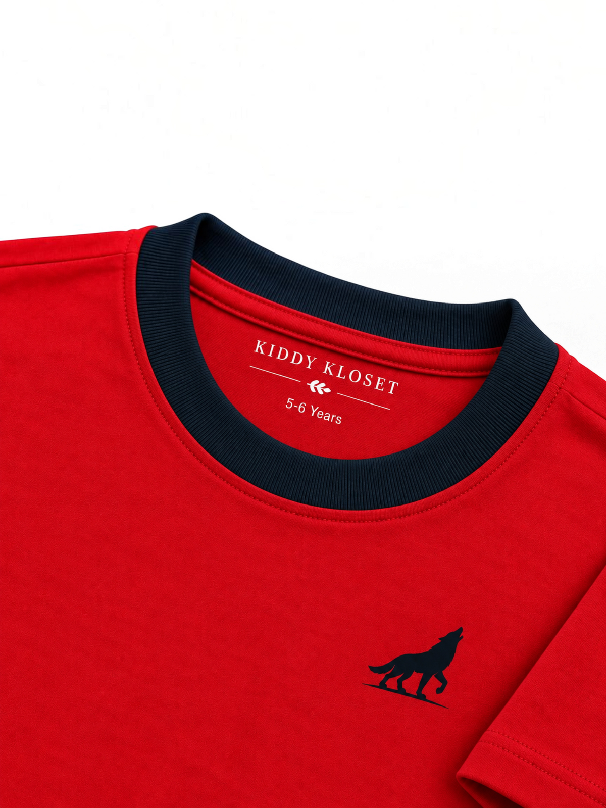 Close up of navy ribbed crew neckline, branded neck print and navy wolf logo on red tee