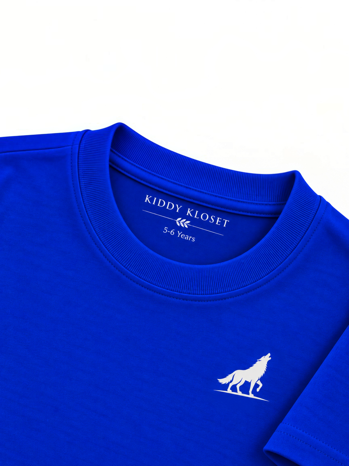 Close up of tonal royal blue ribbed crew neckline, branded neck print and white wolf logo