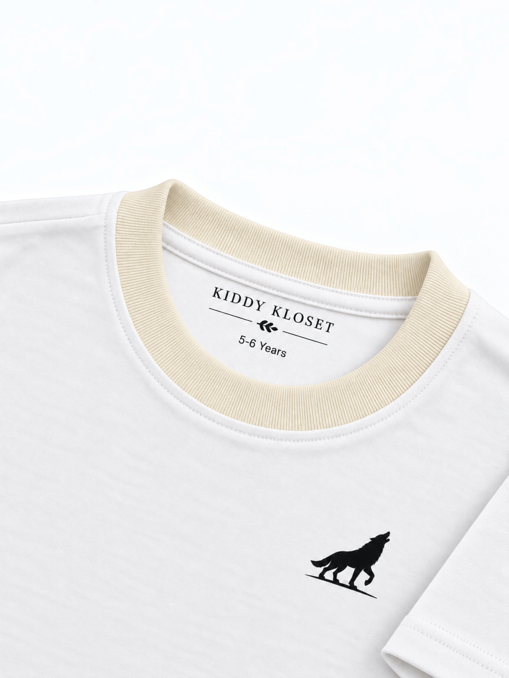 Close up of cream ribbed crew neckline, branded neck print and black wolf logo on white tee