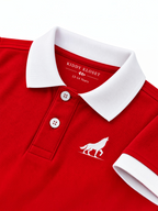Close up of white polo collar, two-button placket and wolf logo on red kids polo shirt