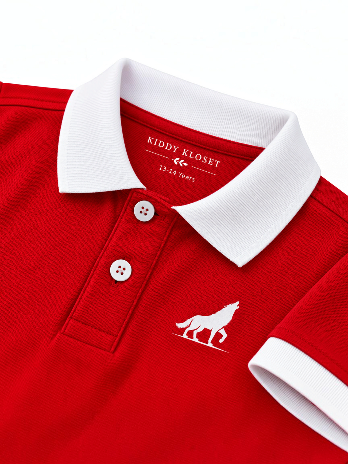 Close up of white polo collar, two-button placket and wolf logo on red kids polo shirt