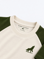 Close up of tonal cream ribbed crew neckline, branded neck label and olive wolf logo