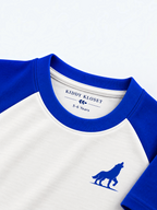 Close up of royal blue ribbed crew neckline, branded neck label and blue wolf logo on white raglan tee