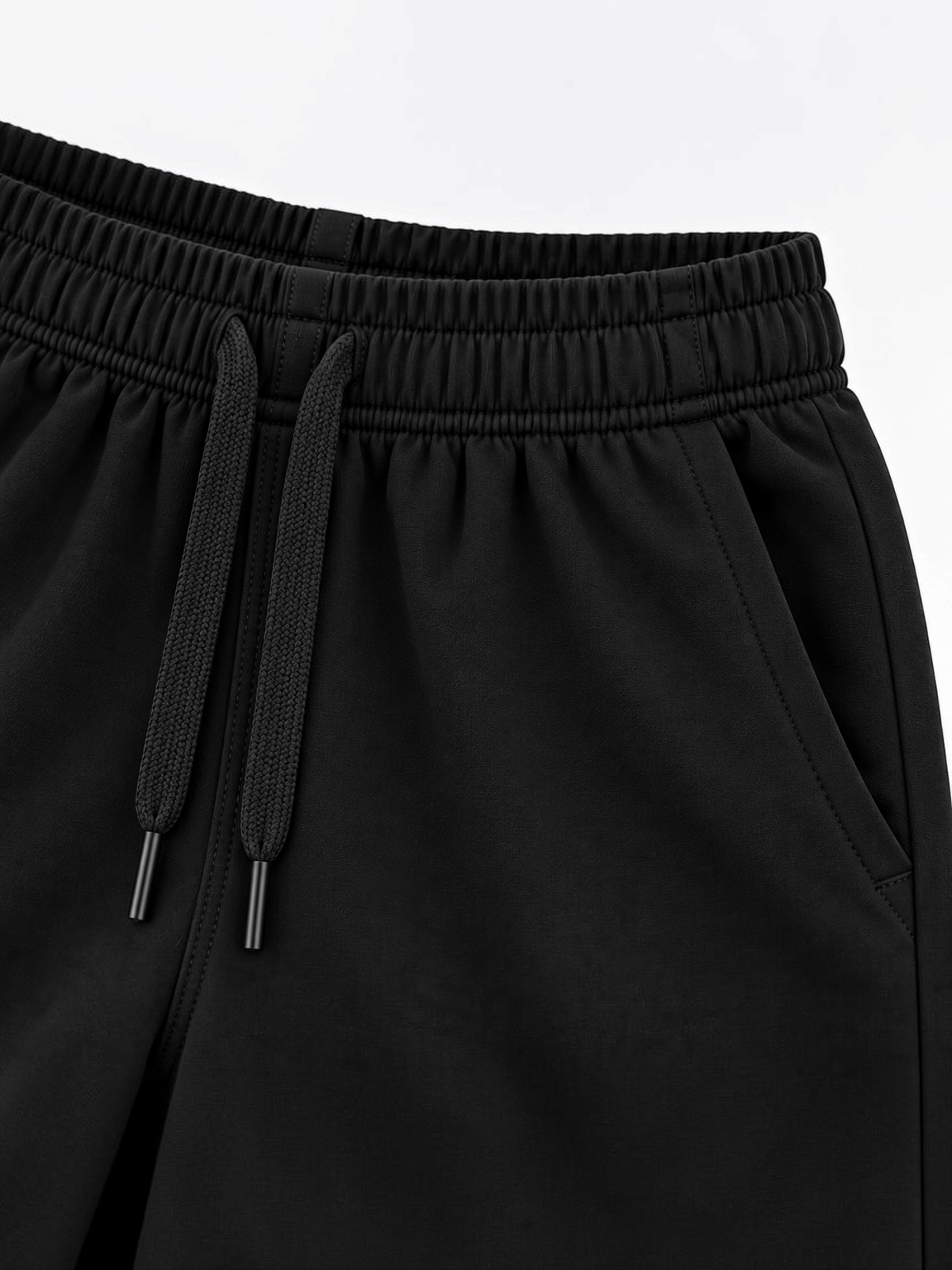 Close up of elasticated waistband, drawcord and side pocket on kids black shorts