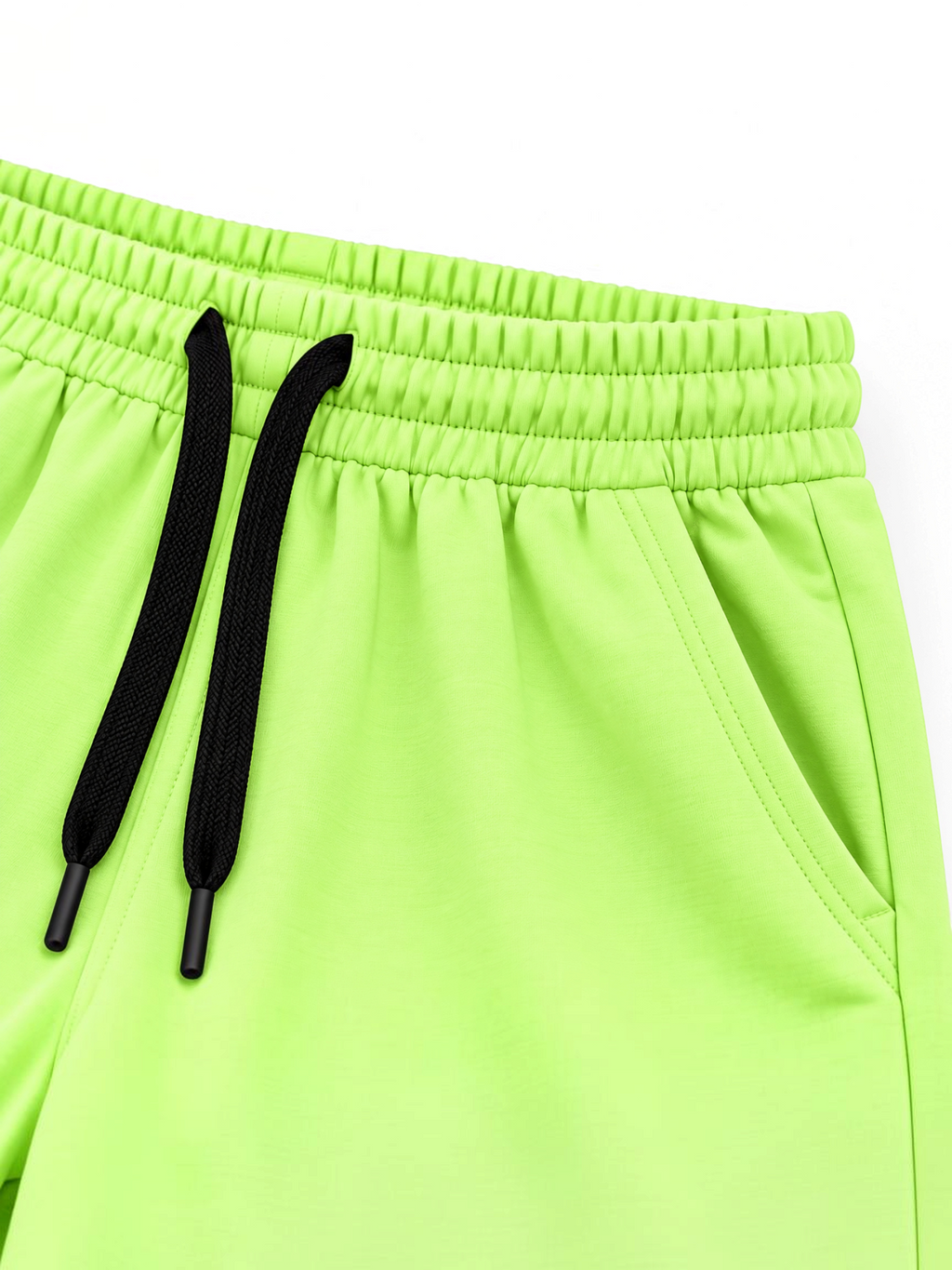 Close up of elasticated waistband, black drawcord and side pocket on kids lime green shorts